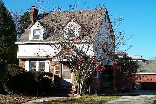 512 Hawthorne Ave, Uniondale, NY 11553 - view of front of property with a chimney and brick siding