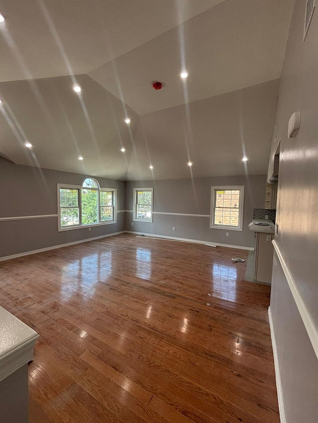 167-12 110th Ave, Jamaica, NY 11433 - unfurnished living room featuring wood finished floors, recessed lighting, and high vaulted ceiling