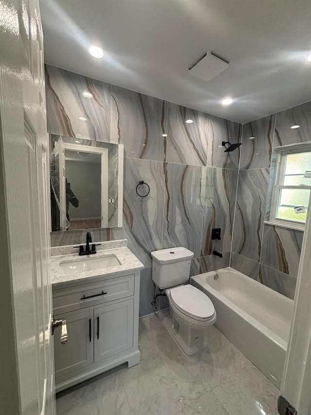 167-12 110th Ave, Jamaica, NY 11433 - bathroom featuring vanity, bathtub / shower combination, marble finish floors, recessed lighting, and tile walls