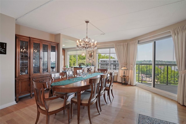 300 High Point Dr Unit 711, Hartsdale, NY 10530 - dining space with light wood finished floors and a chandelier