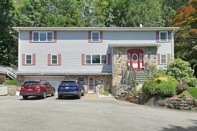 49 Nanny Hagen Rd, Thornwood, NY 10594 - view of front facade featuring stone siding, asphalt driveway, and an attached garage