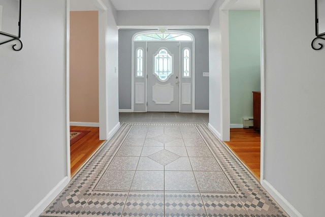 49 Nanny Hagen Rd, Thornwood, NY 10594 - entrance foyer with tile patterned flooring, inlaid floor details, and a baseboard heating unit