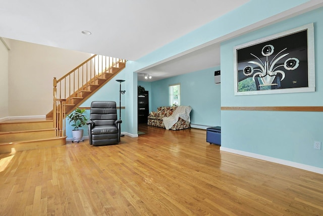 49 Nanny Hagen Rd, Thornwood, NY 10594 - living room featuring stairway, wood finished floors, and a baseboard heating unit