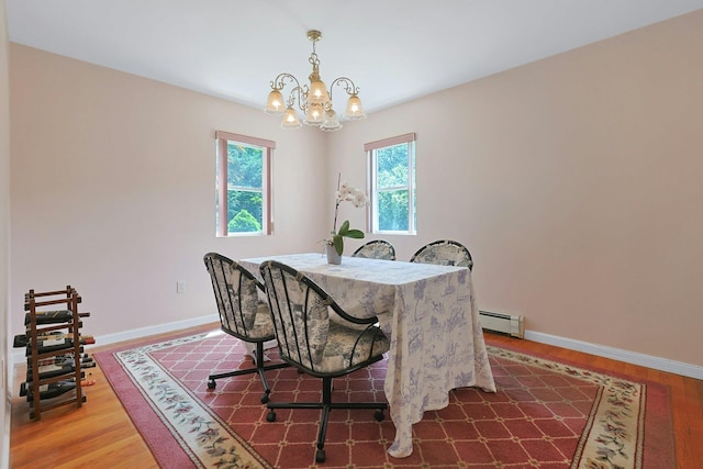 49 Nanny Hagen Rd, Thornwood, NY 10594 - dining space with a baseboard heating unit, a chandelier, and wood finished floors