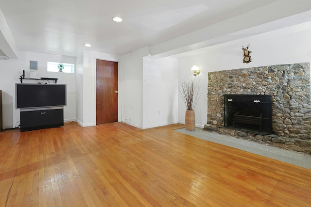 49 Nanny Hagen Rd, Thornwood, NY 10594 - unfurnished living room featuring wood-type flooring and a stone fireplace