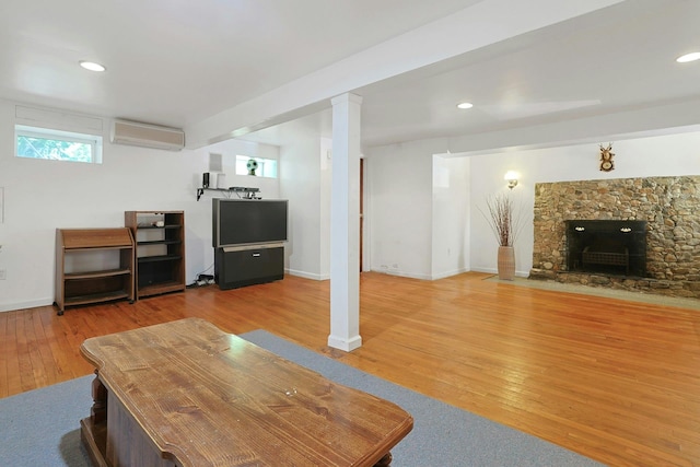 49 Nanny Hagen Rd, Thornwood, NY 10594 - living area with wood finished floors, an AC wall unit, a fireplace, and recessed lighting