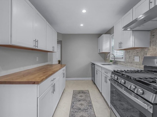 71 Van Nostrand Ave, North Merrick, NY 11566 - kitchen with appliances with stainless steel finishes, exhaust hood, wood counters, decorative backsplash, and recessed lighting