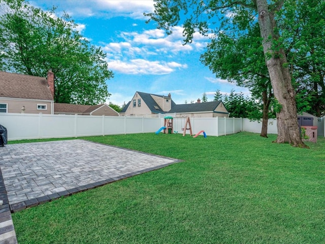 71 Van Nostrand Ave, North Merrick, NY 11566 - fenced backyard with a playground and a patio area