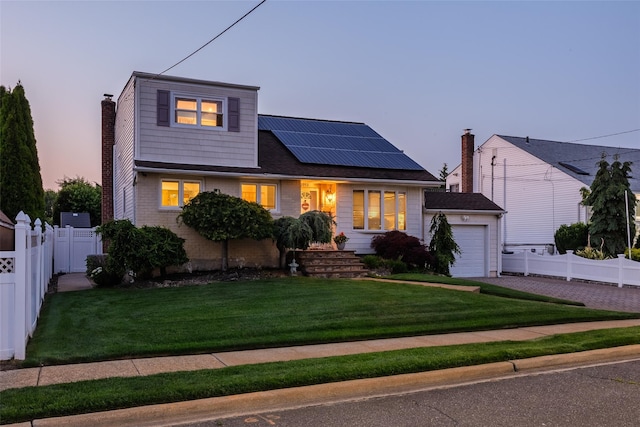 2953 Bluepoint Ct, Wantagh, NY 11793 - view of front of home featuring roof mounted solar panels, an attached garage, driveway, and a chimney