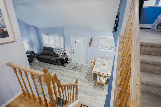 2953 Bluepoint Ct, Wantagh, NY 11793 - stairs with wood finished floors and a baseboard heating unit