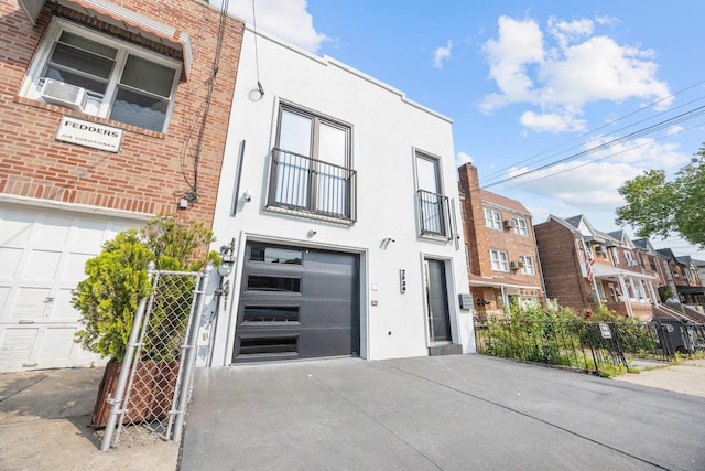 2539 48th St, Astoria, NY 11103 - townhome / multi-family property with an attached garage, driveway, stucco siding, and cooling unit
