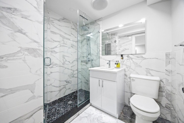 2539 48th St, Astoria, NY 11103 - bathroom featuring tile walls, a marble finish shower, vanity, and marble tiled floors
