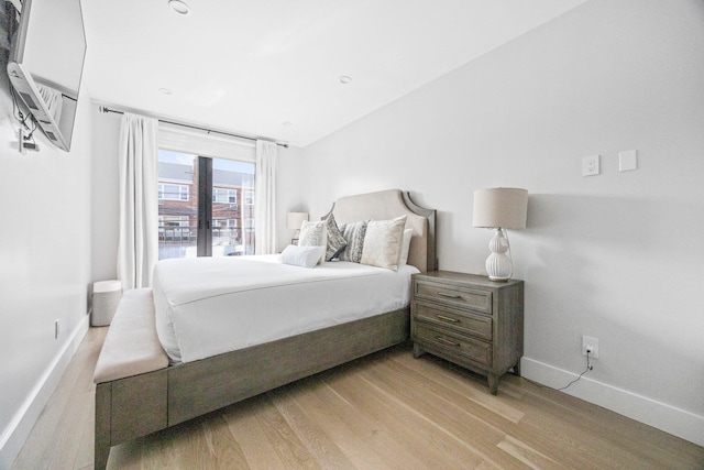 2539 48th St, Astoria, NY 11103 - bedroom featuring light wood-style flooring, a wall unit AC, and vaulted ceiling