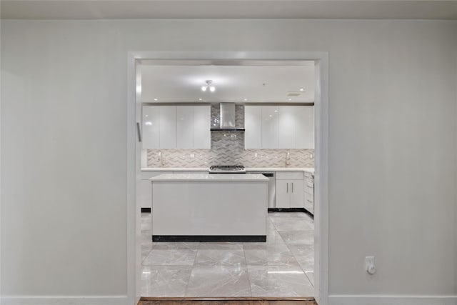 487 W Central Ave Unit 112, Spring Valley, NY 10977 - kitchen featuring wall chimney range hood, light marble finish flooring, white cabinetry, modern cabinets, and tasteful backsplash