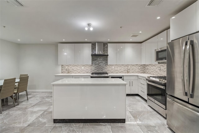487 W Central Ave Unit 112, Spring Valley, NY 10977 - kitchen with stainless steel appliances, modern cabinets, wall chimney exhaust hood, tasteful backsplash, and light countertops