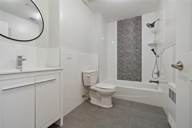 487 W Central Ave Unit 112, Spring Valley, NY 10977 - bathroom with vanity, tub / shower combination, tile walls, tile patterned flooring, and a wainscoted wall
