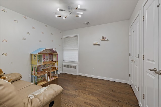 487 W Central Ave Unit 112, Spring Valley, NY 10977 - sitting room featuring radiator heating unit, wood finished floors, and a chandelier