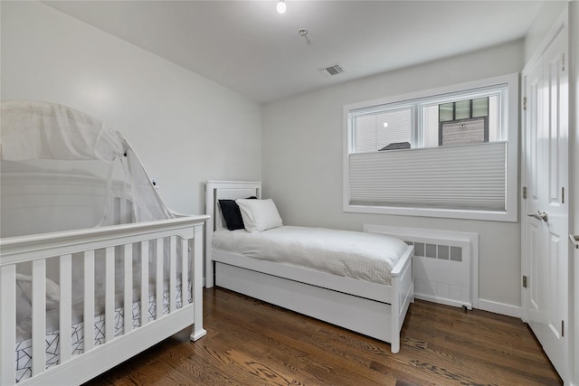 487 W Central Ave Unit 112, Spring Valley, NY 10977 - bedroom featuring radiator heating unit and wood finished floors