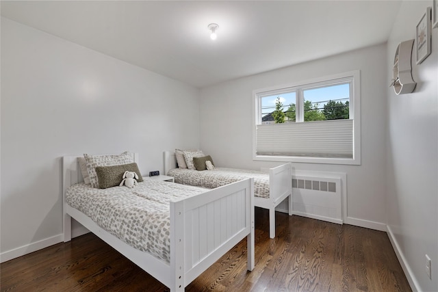 487 W Central Ave Unit 112, Spring Valley, NY 10977 - bedroom with radiator, dark wood finished floors, and a wall mounted AC