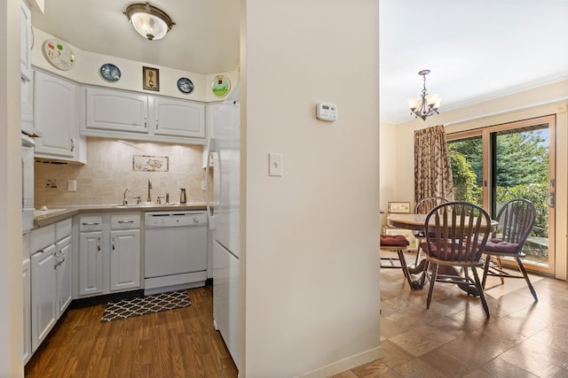 4 Devon Ct Unit B, Yorktown Heights, NY 10598 - kitchen featuring white appliances, decorative backsplash, dark wood-style flooring, white cabinetry, and a chandelier