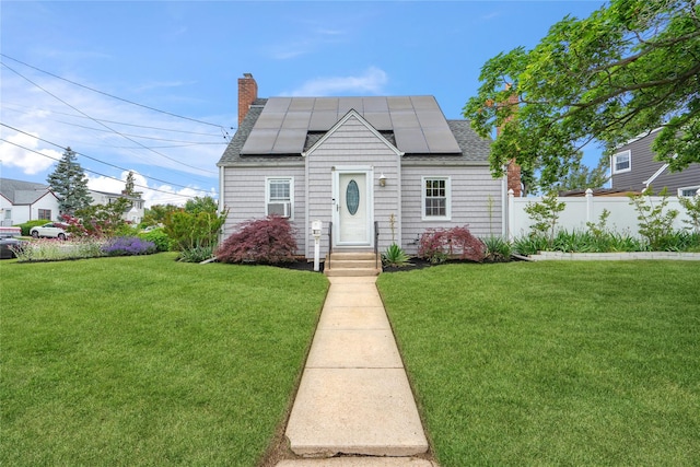 204 Leonard St, North Bellmore, NY 11710 - view of front facade with a shingled roof, roof mounted solar panels, and a chimney