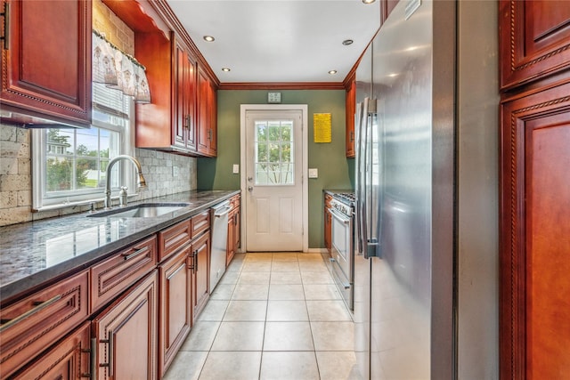 204 Leonard St, North Bellmore, NY 11710 - kitchen featuring appliances with stainless steel finishes, decorative backsplash, light tile patterned flooring, dark stone counters, and crown molding
