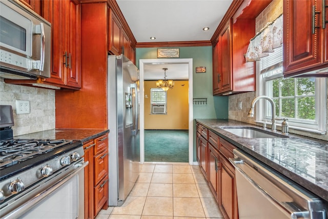 204 Leonard St, North Bellmore, NY 11710 - kitchen featuring appliances with stainless steel finishes, a chandelier, plenty of natural light, light carpet, and ornamental molding