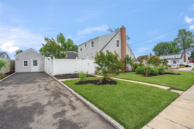 204 Leonard St, North Bellmore, NY 11710 - view of front of house with asphalt driveway and a chimney