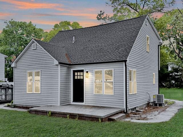 49 Heston Rd, Shirley, NY 11967 - back of house at dusk featuring a lawn, a shingled roof, and a deck