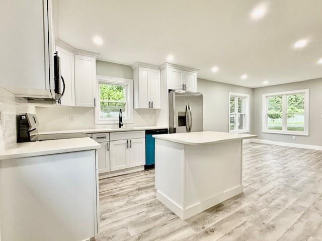 49 Heston Rd, Shirley, NY 11967 - kitchen featuring stainless steel refrigerator with ice dispenser, dishwashing machine, recessed lighting, healthy amount of natural light, and light wood finished floors