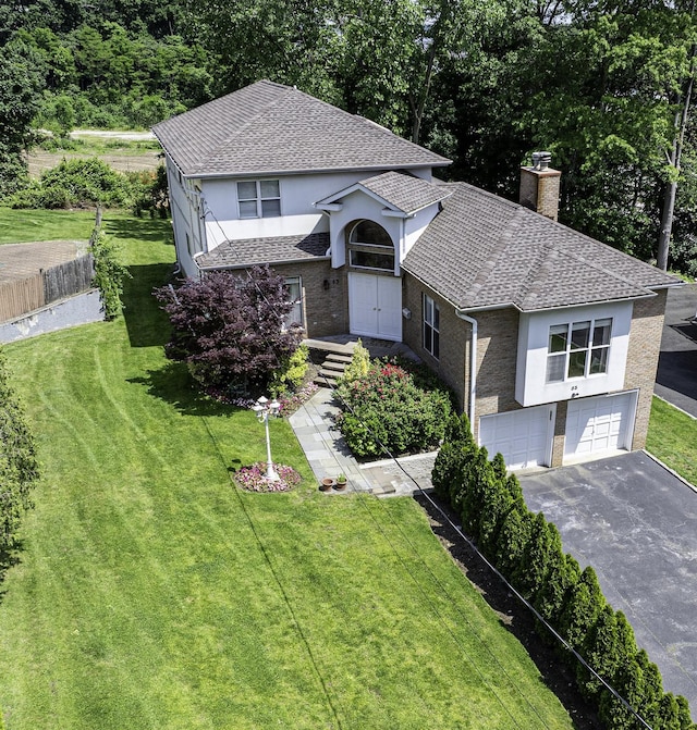 53 Vista Hill Rd, Great Neck, NY 11021 - view of front facade with driveway, a chimney, a garage, stucco siding, and a shingled roof