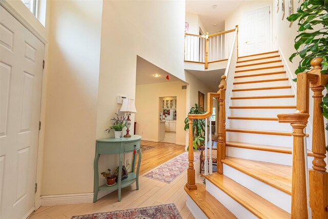 53 Vista Hill Rd, Great Neck, NY 11021 - foyer featuring a high ceiling, wood finished floors, and stairway