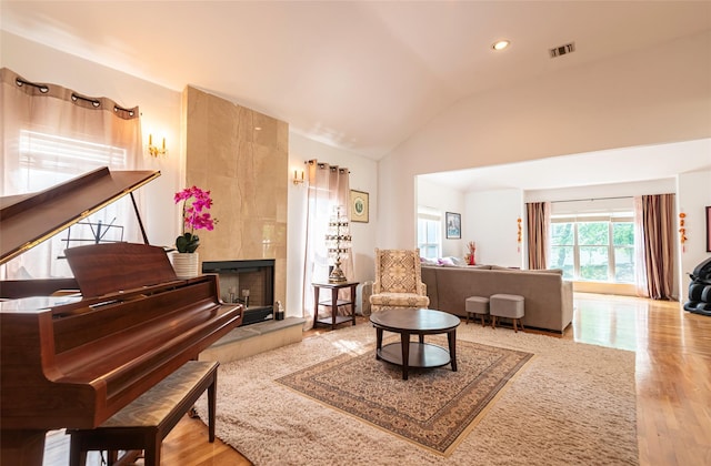 53 Vista Hill Rd, Great Neck, NY 11021 - sitting room featuring lofted ceiling, wood finished floors, recessed lighting, and a tiled fireplace