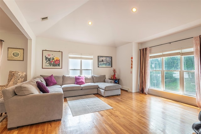 53 Vista Hill Rd, Great Neck, NY 11021 - living area with healthy amount of natural light, lofted ceiling, light wood-type flooring, recessed lighting, and a baseboard heating unit