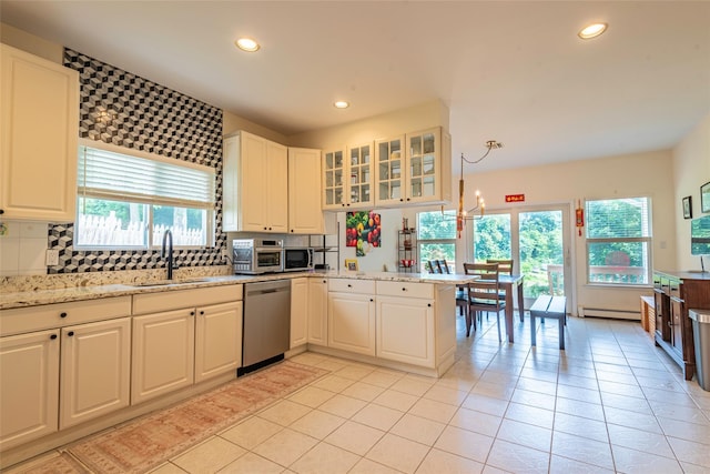 53 Vista Hill Rd, Great Neck, NY 11021 - kitchen with stainless steel appliances, plenty of natural light, recessed lighting, light tile patterned flooring, and a peninsula