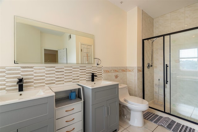 53 Vista Hill Rd, Great Neck, NY 11021 - full bathroom with tile walls, tile patterned flooring, two vanities, a shower stall, and wainscoting