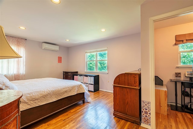 53 Vista Hill Rd, Great Neck, NY 11021 - bedroom with a wall mounted air conditioner, wood finished floors, and recessed lighting