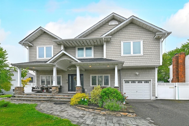250 33rd St, Lindenhurst, NY 11757 - view of front facade with a garage, a porch, and driveway