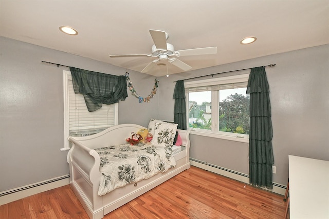 250 33rd St, Lindenhurst, NY 11757 - bedroom with a baseboard radiator, wood finished floors, recessed lighting, and a ceiling fan