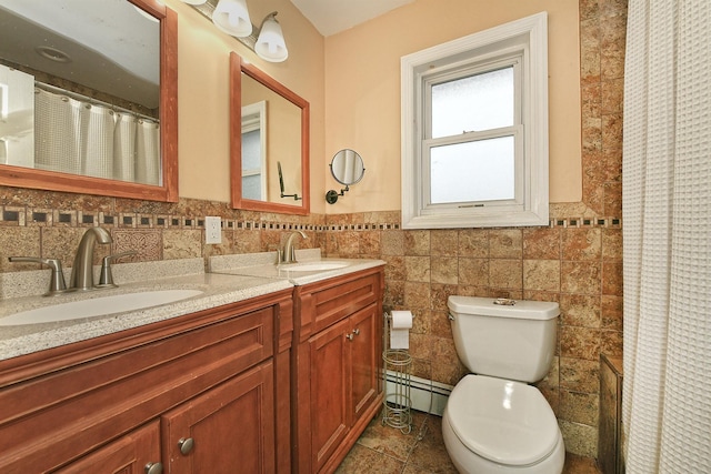 250 33rd St, Lindenhurst, NY 11757 - bathroom featuring a baseboard heating unit, double vanity, a wainscoted wall, tile walls, and curtained shower