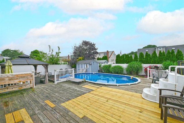 250 33rd St, Lindenhurst, NY 11757 - view of pool with a gazebo, a fenced backyard, a wooden deck, and a storage unit