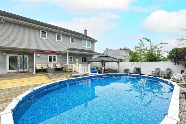 250 33rd St, Lindenhurst, NY 11757 - view of pool with outdoor lounge area, a gazebo, a wooden deck, and a fenced backyard
