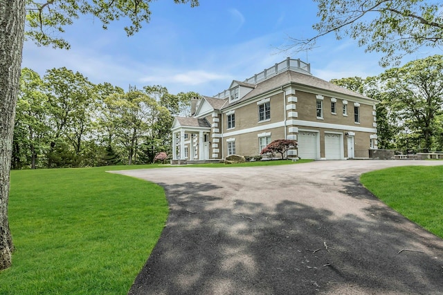 12 Orient Ave, Northport, NY 11768 - view of front of home featuring driveway, a front yard, and an attached garage
