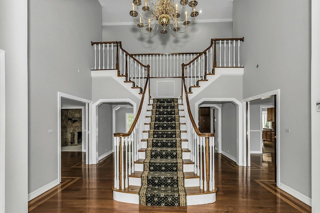 12 Orient Ave, Northport, NY 11768 - stairway featuring a towering ceiling, wood finished floors, a chandelier, and crown molding