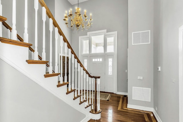 12 Orient Ave, Northport, NY 11768 - foyer featuring a high ceiling, wood finished floors, stairs, and a chandelier