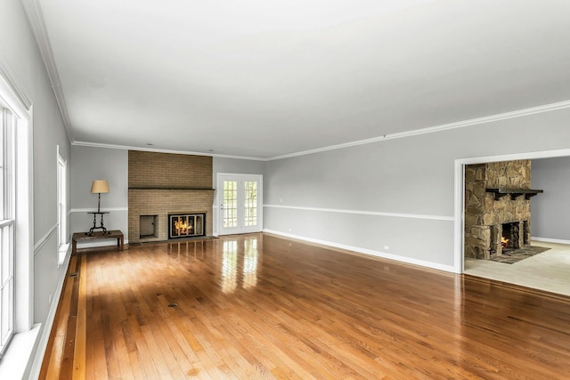 12 Orient Ave, Northport, NY 11768 - unfurnished living room featuring a large fireplace, hardwood / wood-style floors, and ornamental molding