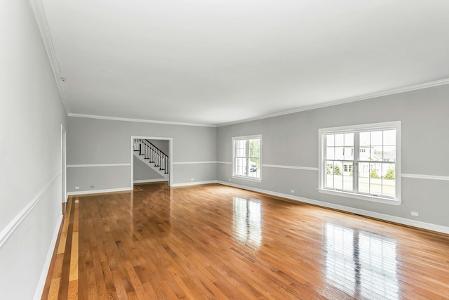 12 Orient Ave, Northport, NY 11768 - spare room with crown molding, light wood-type flooring, and stairway