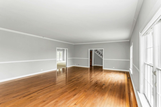 12 Orient Ave, Northport, NY 11768 - empty room featuring hardwood / wood-style flooring, stairs, and crown molding