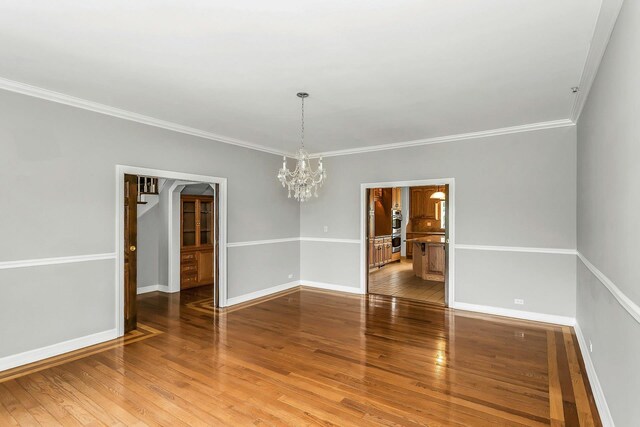 12 Orient Ave, Northport, NY 11768 - unfurnished room with ornamental molding, wood finished floors, and a chandelier