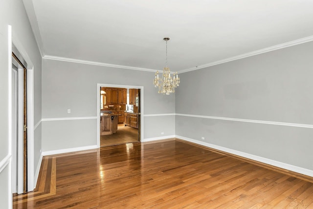 12 Orient Ave, Northport, NY 11768 - unfurnished room featuring a chandelier, wood finished floors, and crown molding